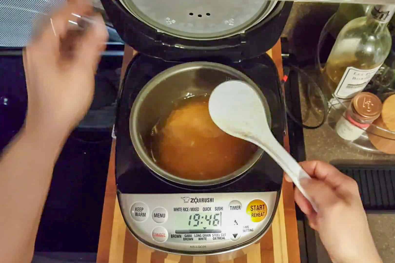 stirred the uncooked seasoned rice with a rice paddle that sits in the rice cooker.