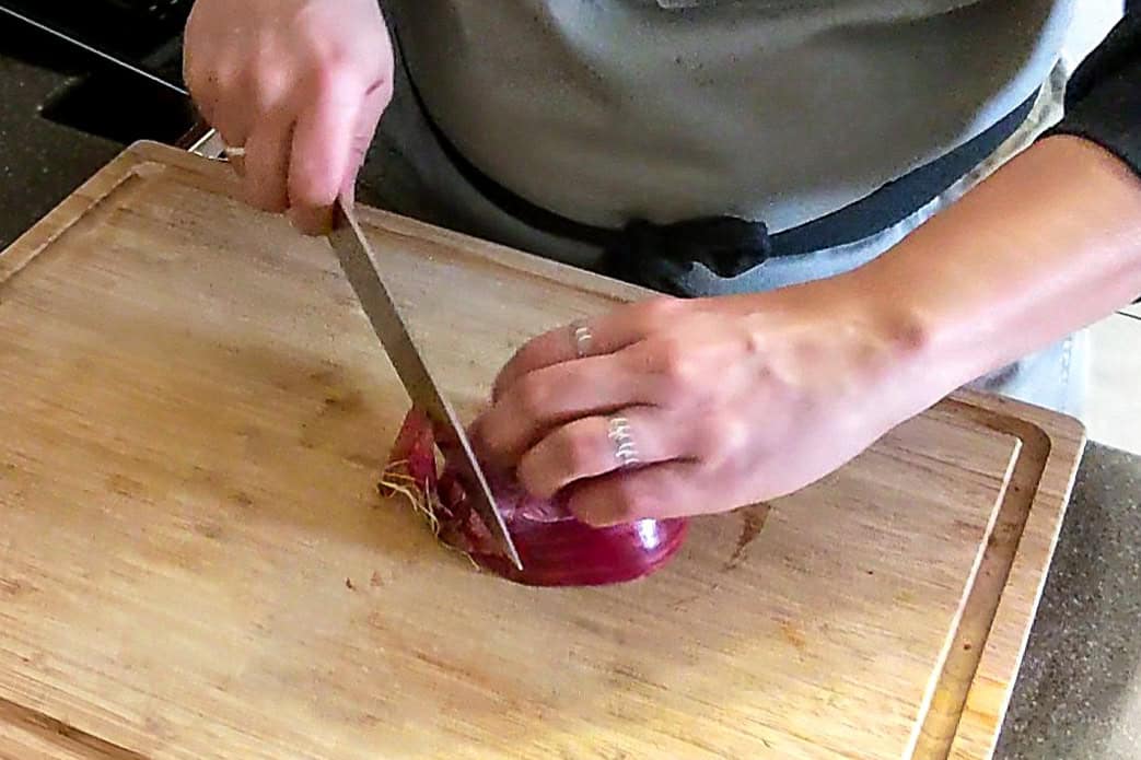 cutting off the ends of the onion.