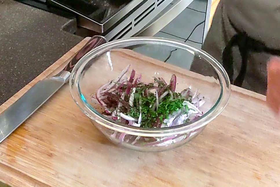 ingredients for the sumac onions in a glass mixing bowl.