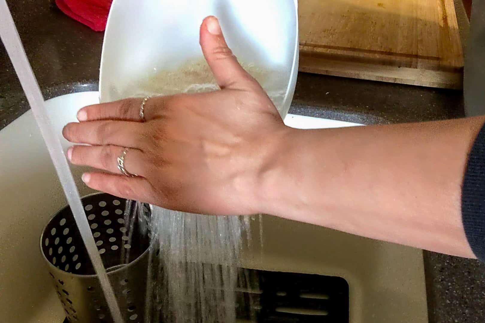 draining the rice from the rice washer.