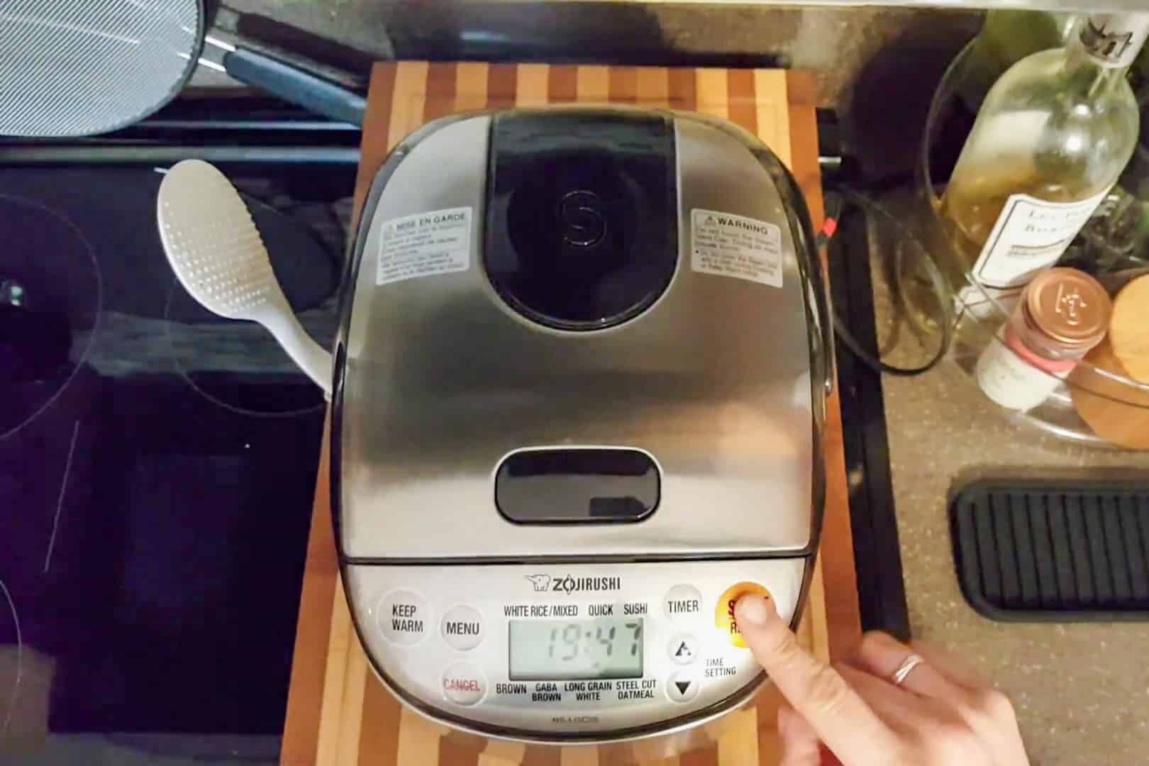 pressing the start button on the Zojrushi rice cooker.