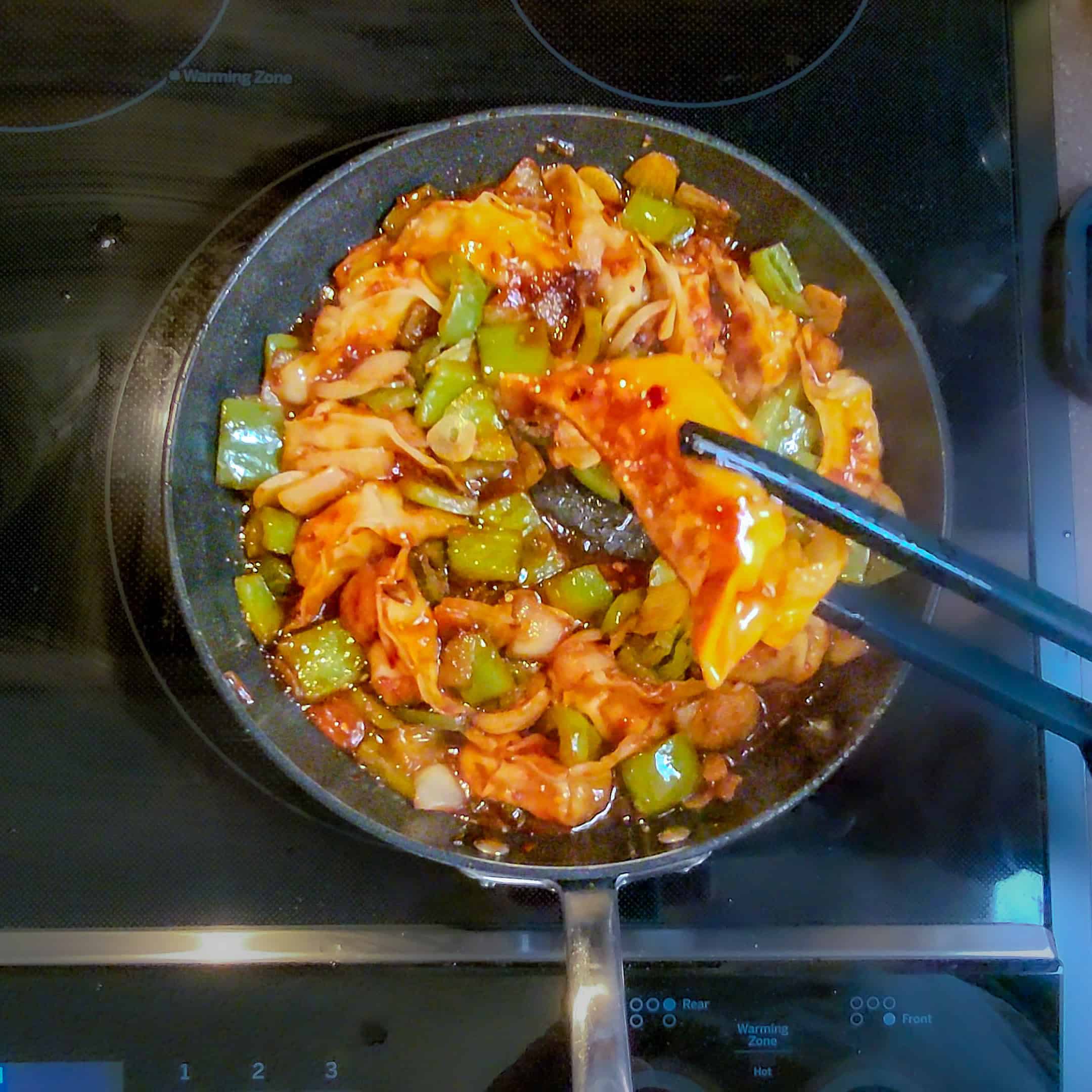 seared potstickers in chili mom sauce with vegetables.