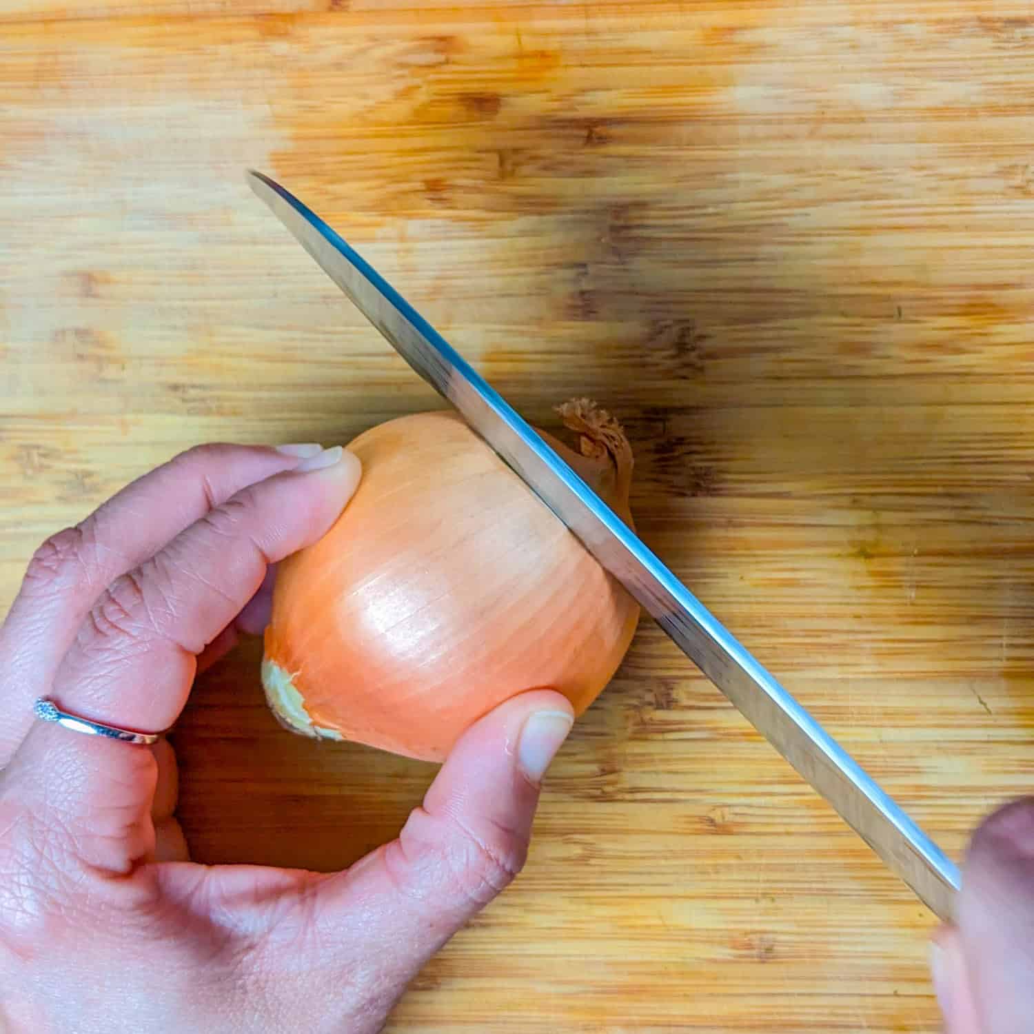 slicing the end of the onion off.