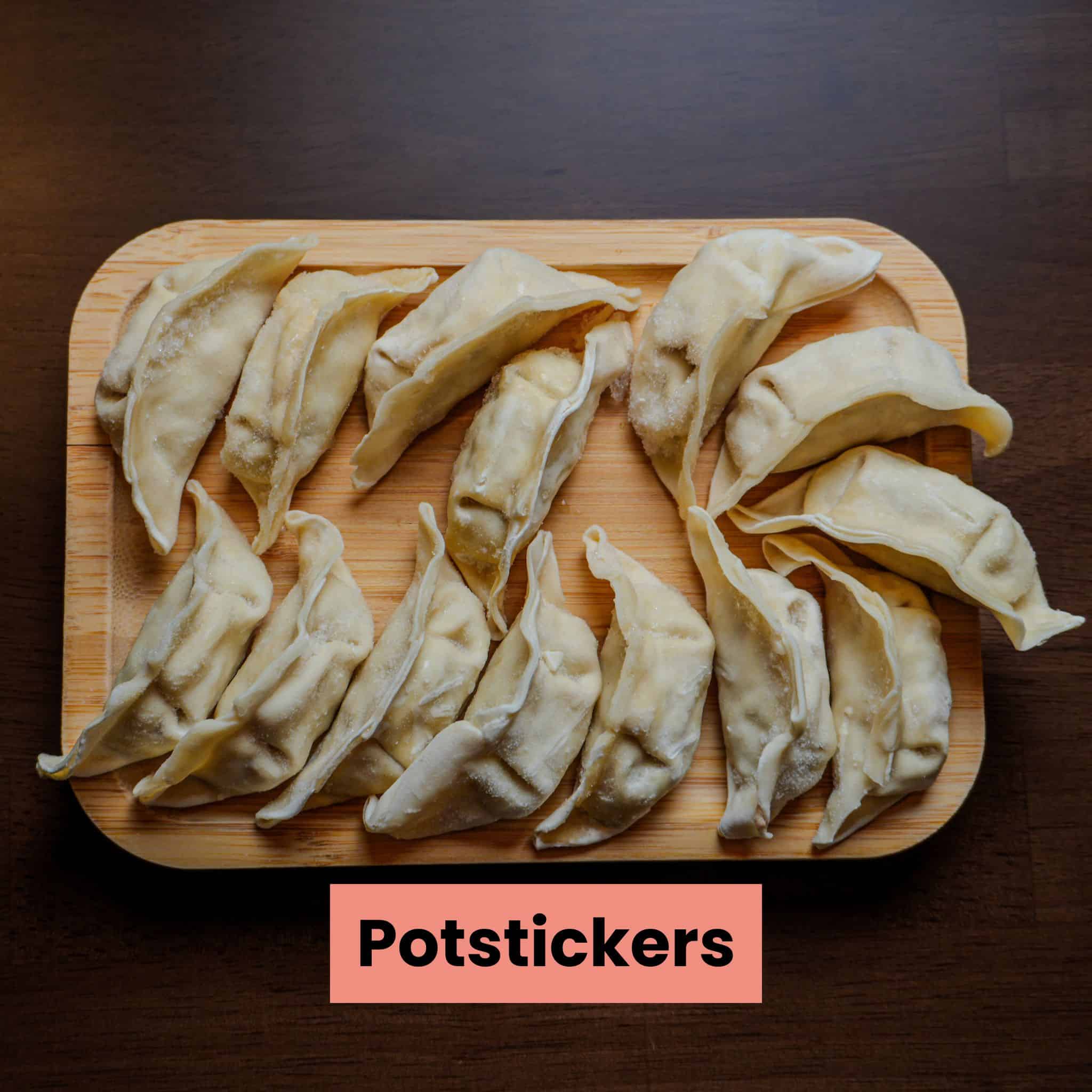 frozen Trader Joe's gyoza potstickers on a wooden plate.